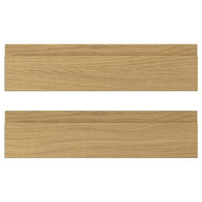 Two VOXTORP drawer fronts with an oak finish, featuring sleek, integrated handles.
