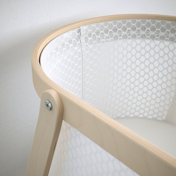 Modern bassinet with breathable mesh and sturdy wooden frame.