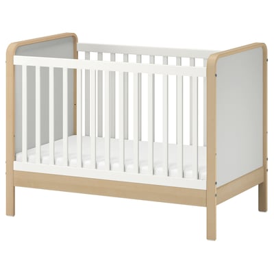 ÄLSKVÄRD white & light wood baby cot with removable side, adjustable base, and guard rail.