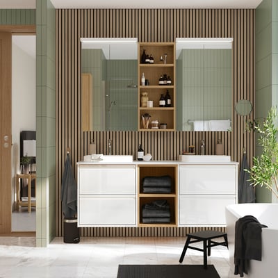 Modern bathroom with green slatted walls, double vanity, black towels, freestanding tub, and vast mirrors.