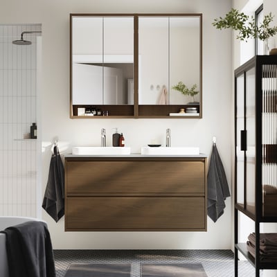 Modern bathroom with floating oak vanity, marble basins, mirror cabinet, and tiled shower.