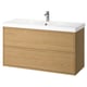 An ÄNGSJÖN light oak bathroom cabinet with a white ceramic basin and a chrome faucet.