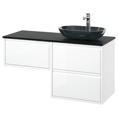 Modern white bathroom vanity with three drawers, black marble countertop, and oval black glass basin.