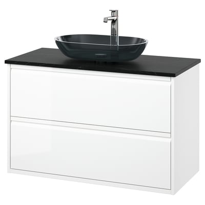 A modern white bathroom vanity with a dark grey glass vessel sink. The cabinet has two drawers and a sleek, minimalist design.