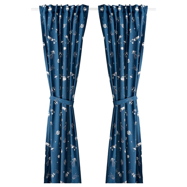 Blue glow-in-dark curtains with space-themed white patterns. Made from recycled polyester and cotton fabric, featuring tab headings and tie-backs.