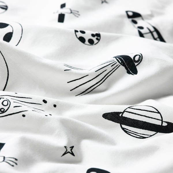 Crisp white duvet cover with bold, black space-themed illustrations. High-quality fabric, detailed prints.