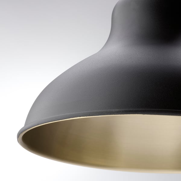 Close-up of sleek black lamp shade with gold inner lining, featuring smooth, high-quality finish.