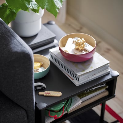 Bamboo bowls on table with plant and books.