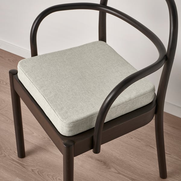 Modern chair with dark frame, light padded seat; memory foam for comfort.