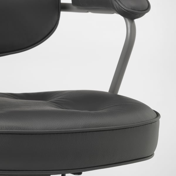 Close-up of black leather office chair, showcasing smooth, high-quality upholstery and sturdy metal frame.