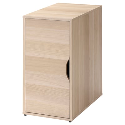An ALEX wooden cabinet in light oak. It has one door with a black handle, a rectangular shape, and a sleek design.