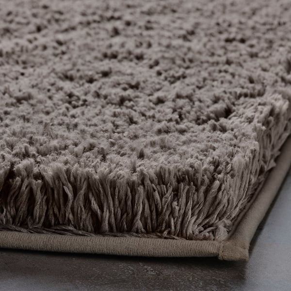 Soft, plush bath mat with ultra-absorbent microfiber, secure latex backing.
