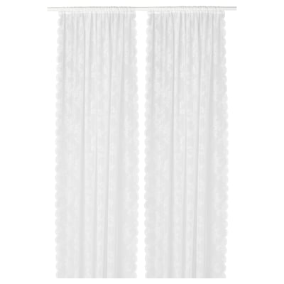 White lace-like curtain panels with floral pattern, sheer, hanging straight.