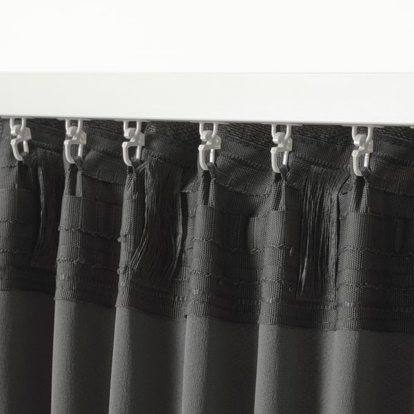 Black curtains with hooks, designed for darkening rooms and hanging easily.