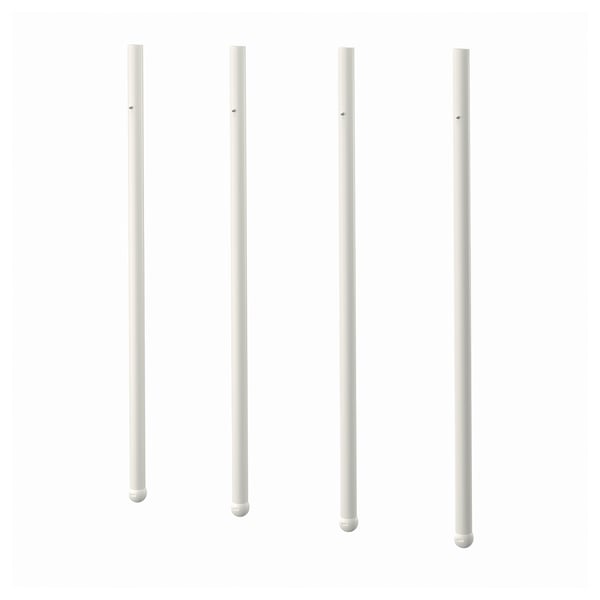 Four white pole-shaped objects, likely part of furniture, arranged in a row.