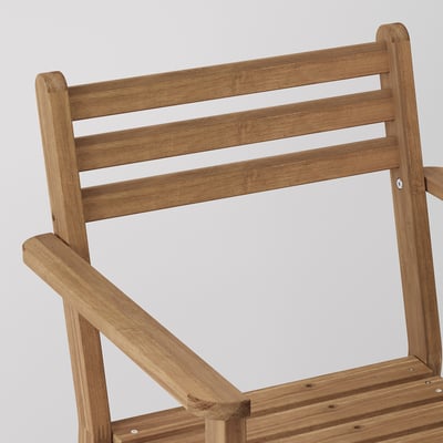 Wooden chair back detail with slatted design, crafted from durable acacia wood.