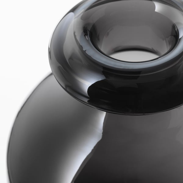 Dark glass vase, smoothly curved, handcrafted with precision.