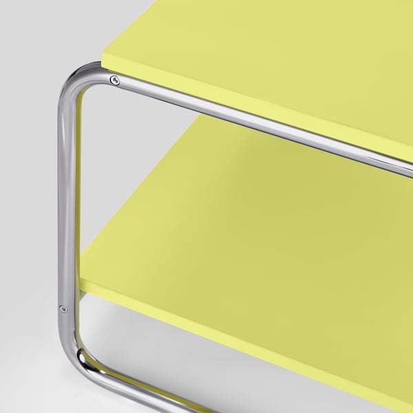 A modern yellow coffee table with a chrome frame, part of the high-quality nytillverkad collection.
