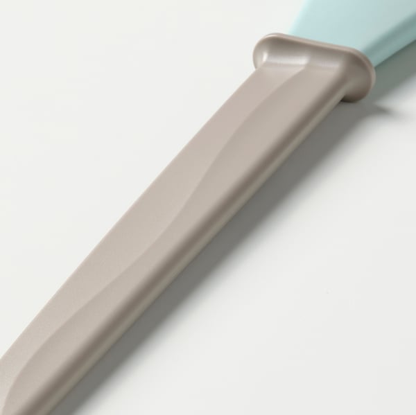 Light blue baking brush with soft beige bristles, lying on a white surface. Quality materials ensure durability and ease of use.