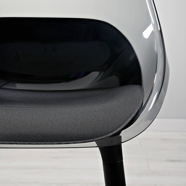 Modern chair with sleek, transparent seat shell & sturdy wooden legs, steeped in contemporary design.
