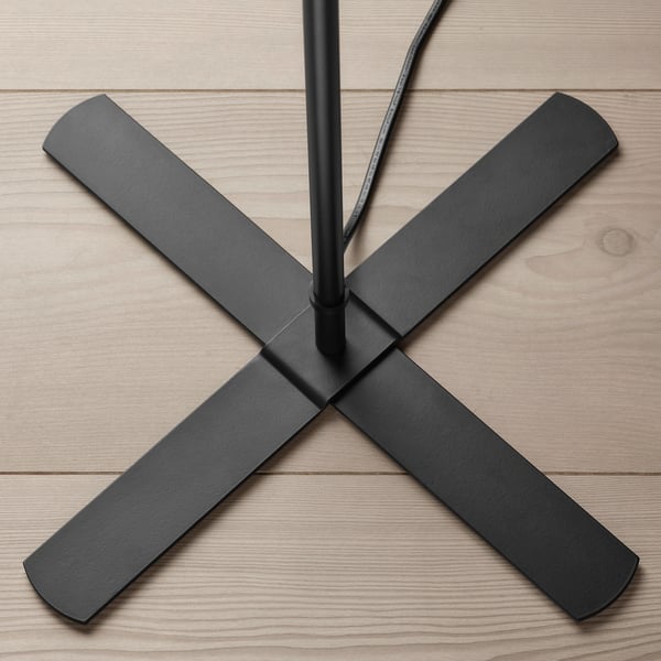 Modern black floor lamp with four extended arms, viewed from above, showcasing sleek design and sturdy construction.