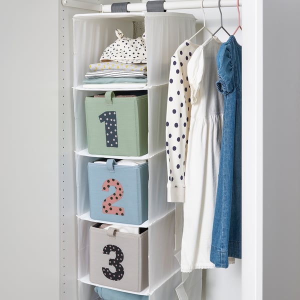 Hanging closet organiser with three numbered storage boxes, holding childrens clothes and accessories.