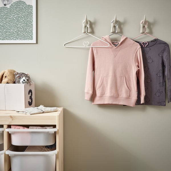 Kids clothing hangers in pastel colours, designed with non-slip surfaces and safe edges, displayed with kids clothes.