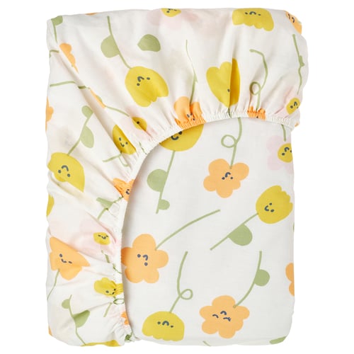 A BARNDRÖMs fitted sheet in white with yellow and orange flower patterns. Made of 100% cotton, it a ruffled edge.