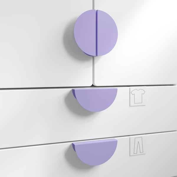 Three purple BEGRIPA handles on white drawers. Top handle is circular, side handles are semi-circular. Easy-grip design for children.