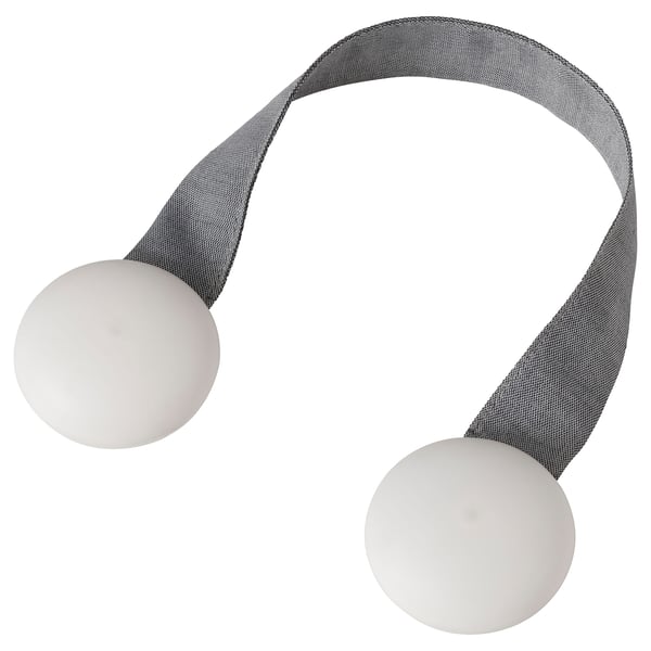 A BERGKLEMATIS tie-back in grey fabric with white magnetic ends, ideal for securing curtains or draperies.