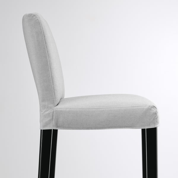 Light grey upholstered chair; high back, black legs; stylish and comfortable.