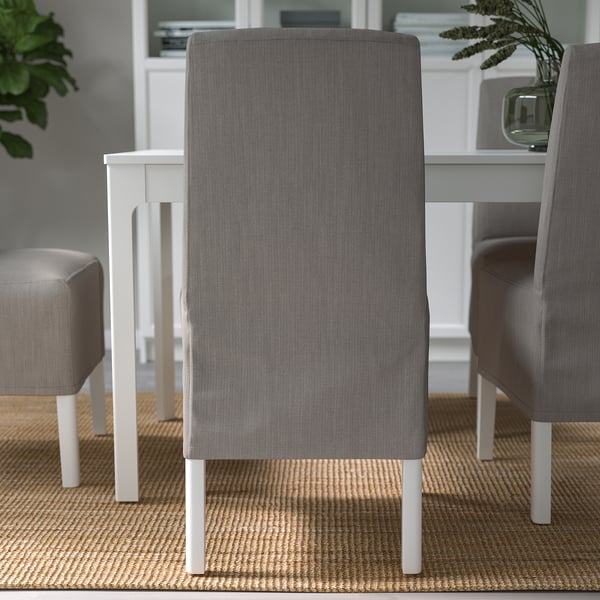 Chic dining chair with grey cover, white legs, padding, and lumbar support.