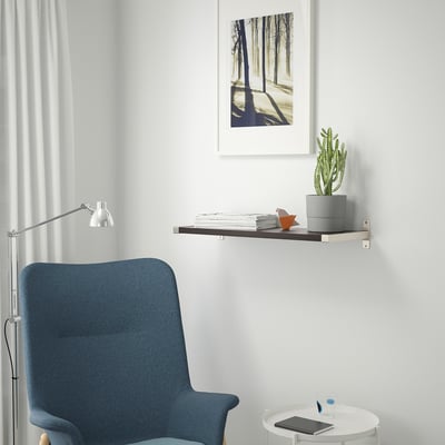 Modern workspace with shelf, chair, lamp, table, and decor.