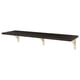 A black BERGSHULT wall shelf. Its rectangular with beveled and smooth edges, supported by light wooden brackets.