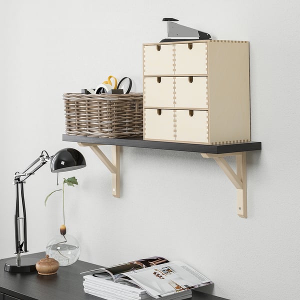 Wall-mounted shelf displays items, with a maximum load of 10 kg. It has a bevelled and smooth edge, suitable for various rooms.