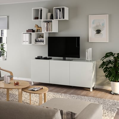Modern living room with BESTÅ tv unit, beige sofa, and house plant.