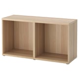 An ikea BESTÅ wooden storage unit in light oak. Its rectangular with open compartments on the front for display or storage.
