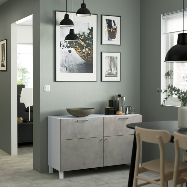 Modern living room with BESTÅ sideboard, pendant lights, framed pictures, and decorative items.