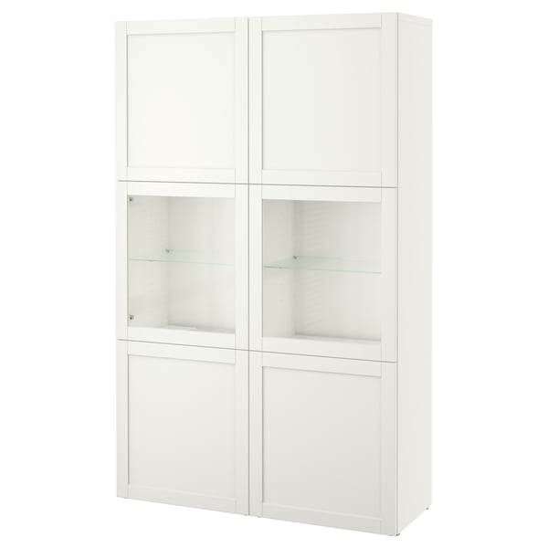 A white BESTÅ storage unit with glass doors and adjustable shelves, combining display and hidden storage.