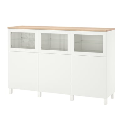 White BESTÅ cabinet: modern, wooden top, glass doors, adjustable shelves, four legs.