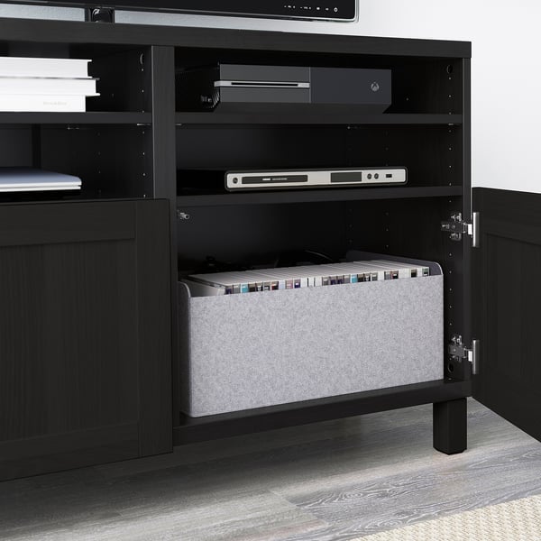 Black BESTÅ tv bench with adjustable shelves, cable management, and a gray organizer bin.