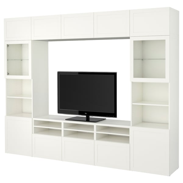 White BESTÅ tv stand with shelves, featuring a flat-screen tv and glass doors.