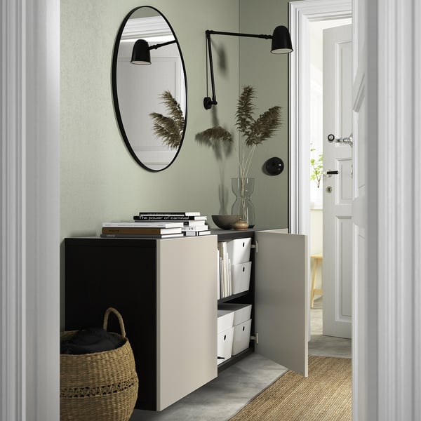 BESTÅ cabinet with mirror, lights, adjustable shelves, and soft-close hinges.