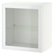 A white BESTÅ cabinet with clear glass door displaying storage space inside.