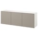 A white BESTÅ wall-mounted cabinet with three light gray doors, offering modern and airy storage.