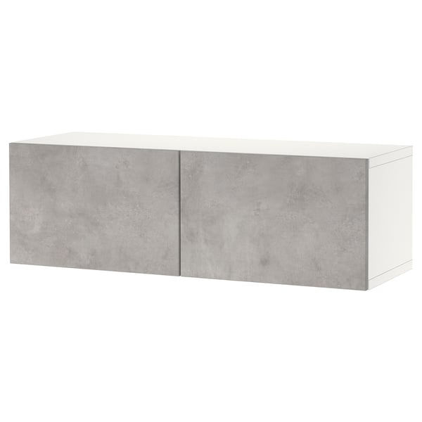 A white and grey BESTÅ storage unit with two closed doors, made of particleboard and laminate, featuring a rectangular shape with sleek design.