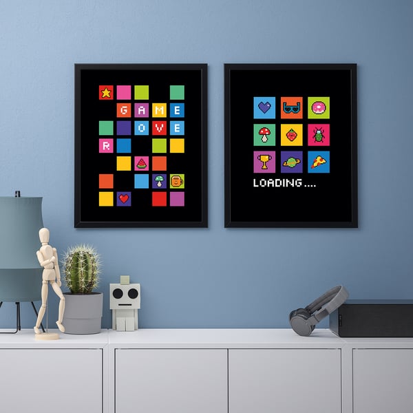 Retro game posters on wall, below, cabinet with decor: wooden figure, cactus, robot, telescope. Playful gaming space.