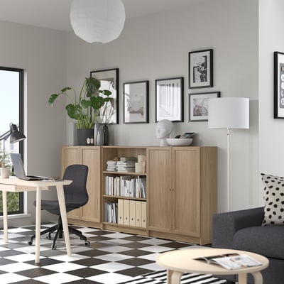 Home office with BILLY bookcase, chair, coffee table, sofa, and decor.