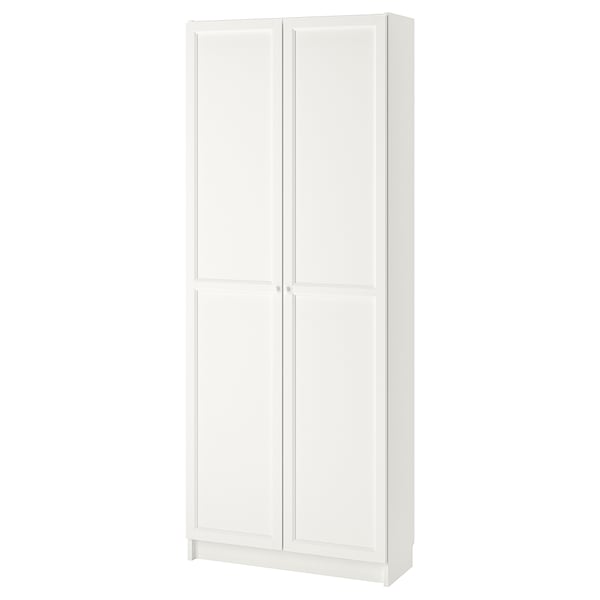 A white BILLY bookcase with doors. Its made of particleboard and has a simple, rectangular design with adjustable shelves.