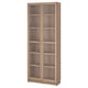 The BILLY bookcase a tall, light oak design with glass doors, displaying five adjustable shelves.